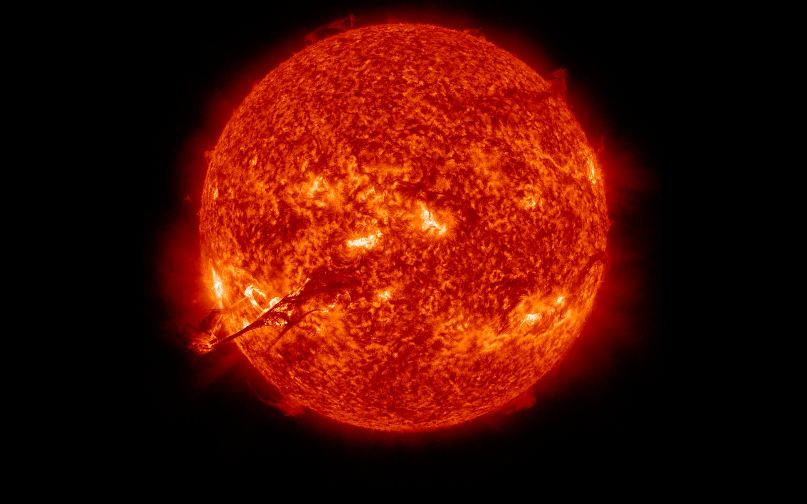 SDO 304 angstrom image of the Sun on August 31, 2012, with a long dark filament of plasma erupting from the lower left of the disk